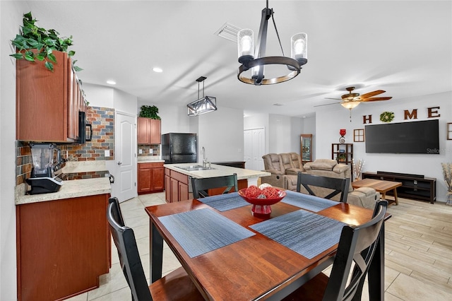 10409 Candleberry Woods Ln, Gibsonton, FL 33534 - dining space with ceiling fan, a chandelier, recessed lighting, and light tile patterned floors