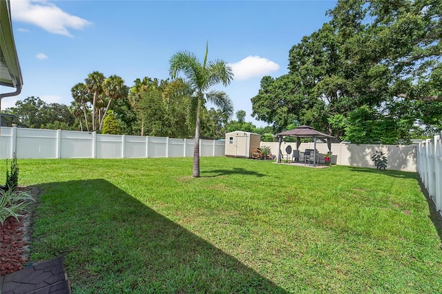 10409 Candleberry Woods Ln, Gibsonton, FL 33534 - fenced backyard with a gazebo, a storage unit, and a patio
