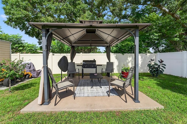 10409 Candleberry Woods Ln, Gibsonton, FL 33534 - fenced backyard featuring a gazebo, a patio, grilling area, and an outdoor living space