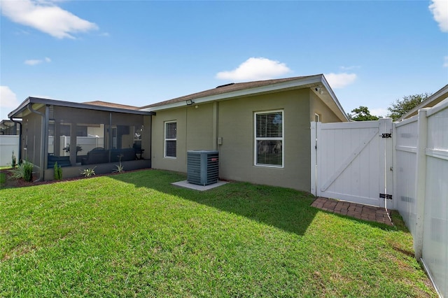 10409 Candleberry Woods Ln, Gibsonton, FL 33534 - rear view of house featuring a gate, a sunroom, and stucco siding