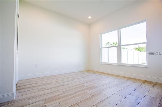 669 Lake Shore Pkwy, Davenport, FL 33896 - empty room with light wood finished floors and recessed lighting