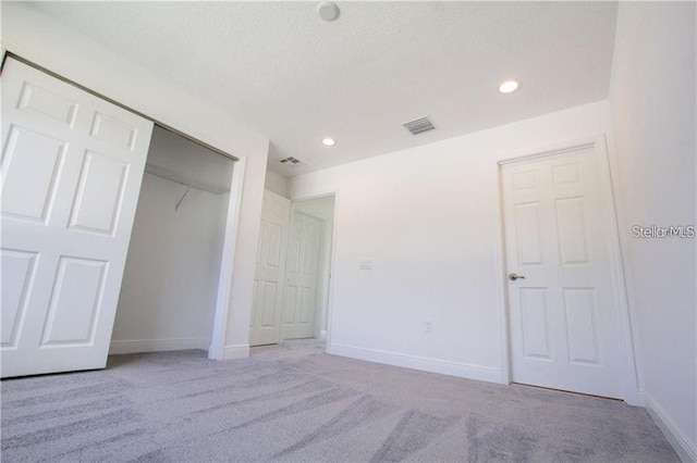 669 Lake Shore Pkwy, Davenport, FL 33896 - unfurnished bedroom featuring carpet flooring, a closet, recessed lighting, and a textured ceiling