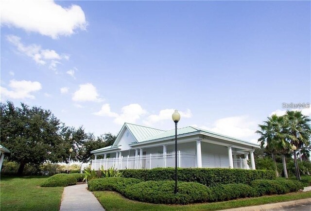 669 Lake Shore Pkwy, Davenport, FL 33896 - view of side of home featuring a metal roof