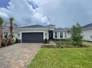 4704 Isonzo Way, Wesley Chapel, FL 33543 - ranch-style home featuring a garage, decorative driveway, and a front lawn