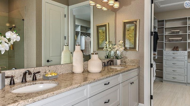 4704 Isonzo Way, Wesley Chapel, FL 33543 - bathroom with double vanity, a stall shower, and a spacious closet