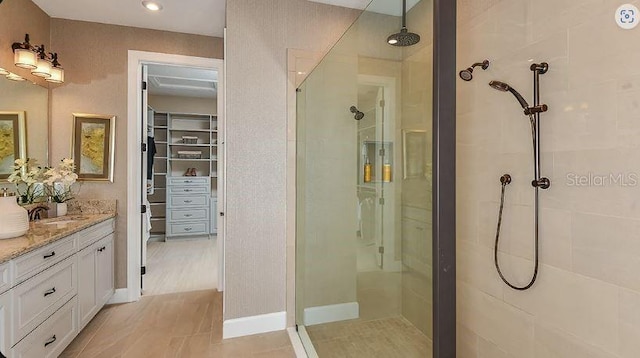 4704 Isonzo Way, Wesley Chapel, FL 33543 - full bathroom featuring tiled shower, vanity, and a walk in closet
