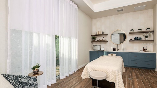 4704 Isonzo Way, Wesley Chapel, FL 33543 - bedroom featuring bar with sink and wood tiled floors