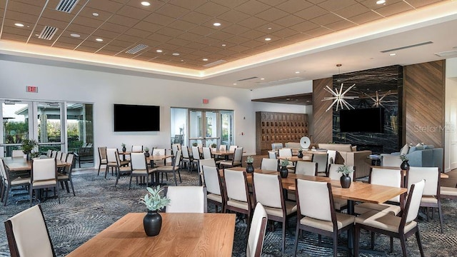 4704 Isonzo Way, Wesley Chapel, FL 33543 - dining area with a tray ceiling, recessed lighting, wood walls, and carpet