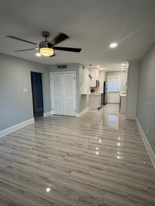 208 Danube Ave Unit 204, Tampa, FL 33606 - unfurnished living room with ceiling fan and light wood-style floors
