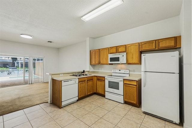 1713 Retreat Cir, Clermont, FL 34714 - kitchen featuring white appliances, a peninsula, brown cabinets, light countertops, and light tile patterned floors