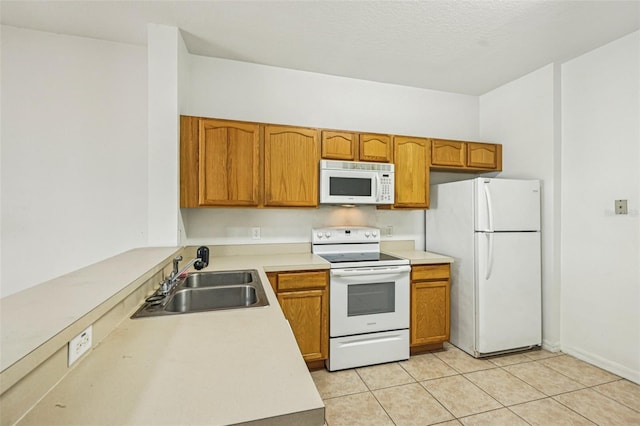 1713 Retreat Cir, Clermont, FL 34714 - kitchen with white appliances, light countertops, light tile patterned flooring, and brown cabinetry