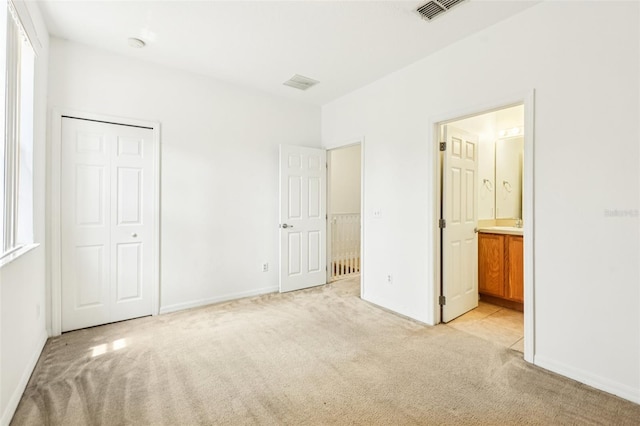 1713 Retreat Cir, Clermont, FL 34714 - unfurnished bedroom featuring light carpet, ensuite bathroom, and a closet
