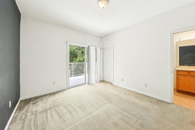 1713 Retreat Cir, Clermont, FL 34714 - unfurnished bedroom with access to exterior, light colored carpet, and ensuite bath
