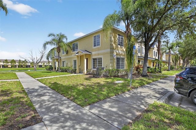 10737 Keys Gate Dr, Riverview, FL 33579 - traditional home with a residential view, a front yard, and stucco siding