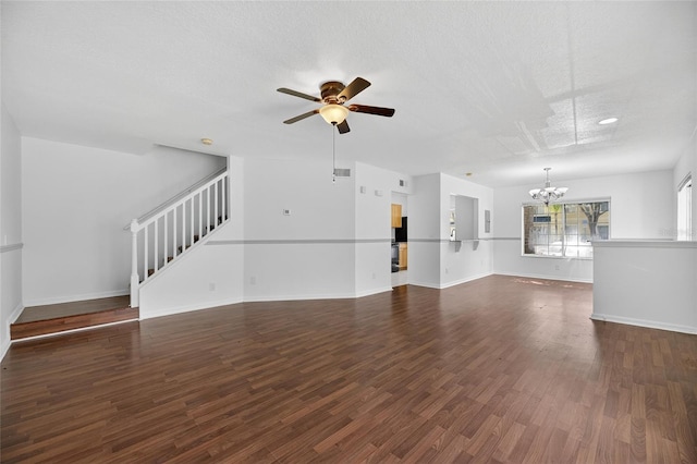 10737 Keys Gate Dr, Riverview, FL 33579 - unfurnished living room featuring a chandelier, a ceiling fan, stairs, wood finished floors, and a textured ceiling