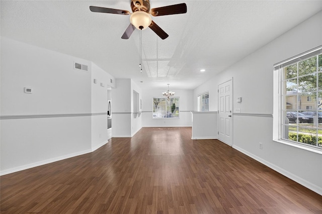 10737 Keys Gate Dr, Riverview, FL 33579 - unfurnished living room with a chandelier, dark wood-style floors, a textured ceiling, and a ceiling fan