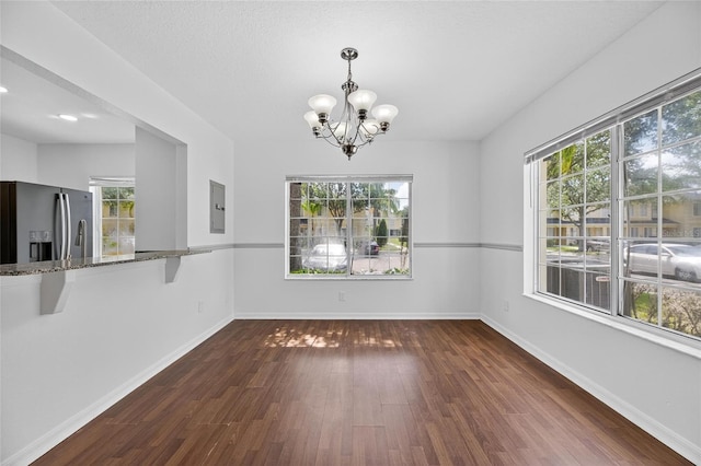10737 Keys Gate Dr, Riverview, FL 33579 - unfurnished dining area with a chandelier, dark wood-style flooring, and electric panel