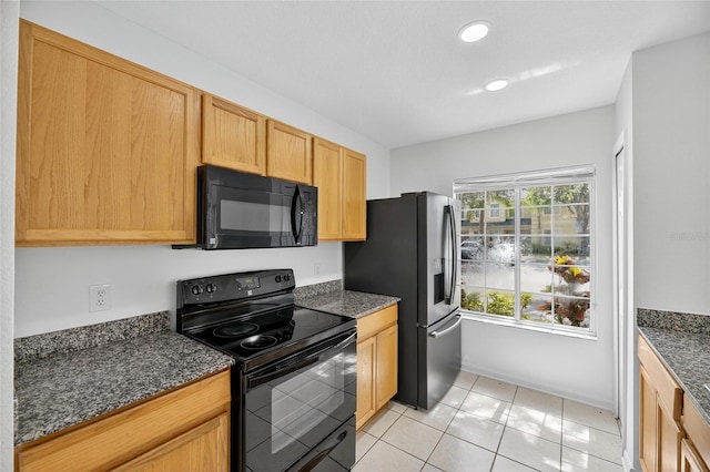 10737 Keys Gate Dr, Riverview, FL 33579 - kitchen with black appliances, dark stone counters, light tile patterned floors, and recessed lighting