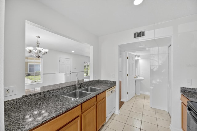 10737 Keys Gate Dr, Riverview, FL 33579 - kitchen featuring white dishwasher, light tile patterned floors, a chandelier, dark stone countertops, and brown cabinetry