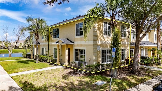 10737 Keys Gate Dr, Riverview, FL 33579 - view of front of property featuring stucco siding, a water view, and a front lawn