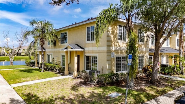 10737 Keys Gate Dr, Riverview, FL 33579 - view of property featuring stucco siding, a water view, and a front yard