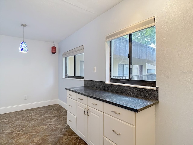 11718 Raintree Village Blvd Unit C, Temple Terrace, FL 33617 - kitchen with dark countertops, white cabinetry, and pendant lighting