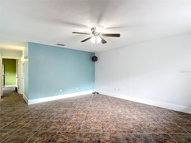11718 Raintree Village Blvd Unit C, Temple Terrace, FL 33617 - spare room featuring ceiling fan, stone finish flooring, and a textured ceiling