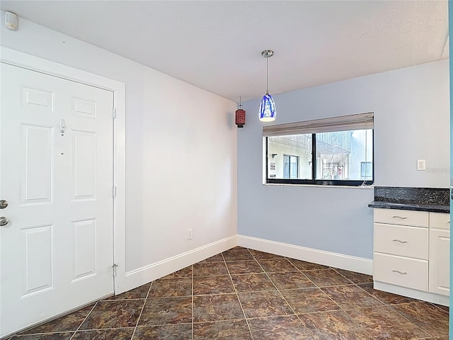 11718 Raintree Village Blvd Unit C, Temple Terrace, FL 33617 - unfurnished dining area with baseboards