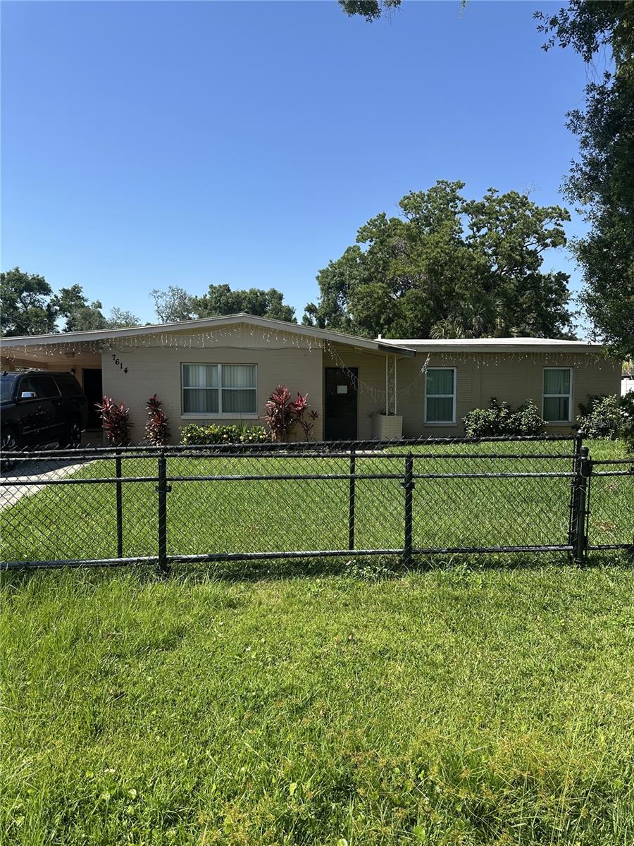 7614 35th Ave S, Tampa, FL 33619 - view of front of house featuring a carport