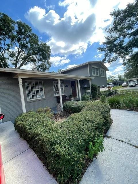 408 Blueberry Ln, Brandon, FL 33510 - view of front facade featuring brick siding and covered porch