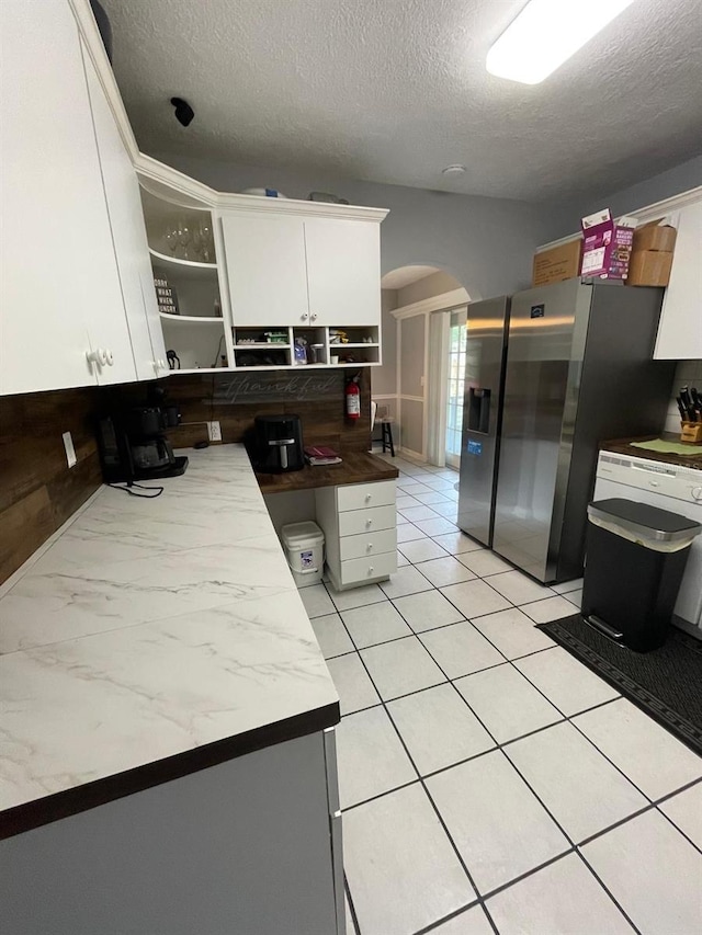 408 Blueberry Ln, Brandon, FL 33510 - kitchen with arched walkways, stainless steel fridge with ice dispenser, open shelves, a textured ceiling, and white cabinets