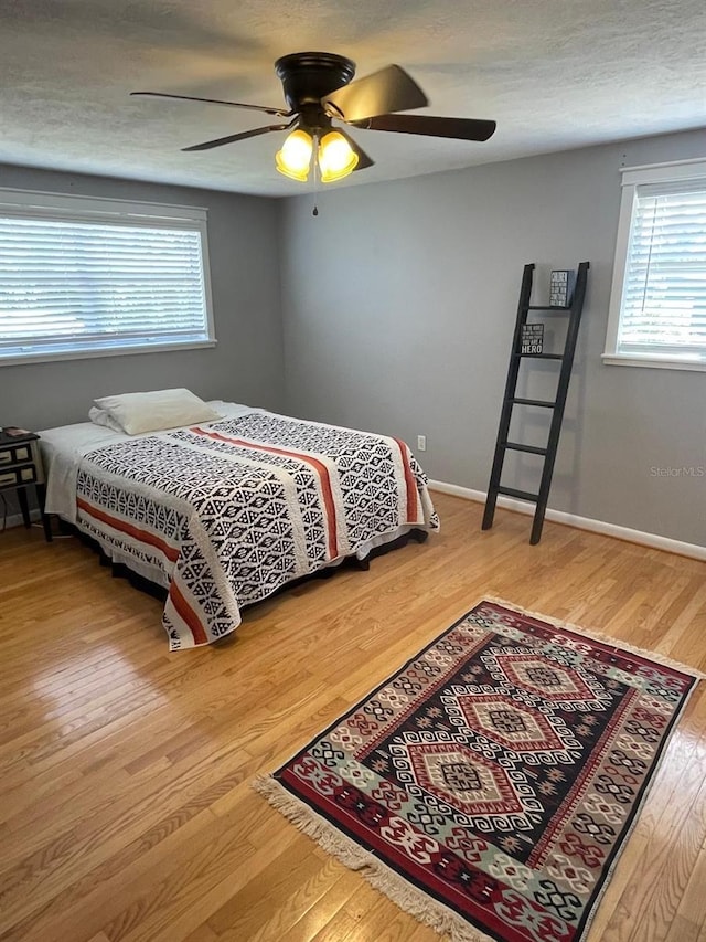 408 Blueberry Ln, Brandon, FL 33510 - bedroom featuring multiple windows, wood finished floors, and ceiling fan