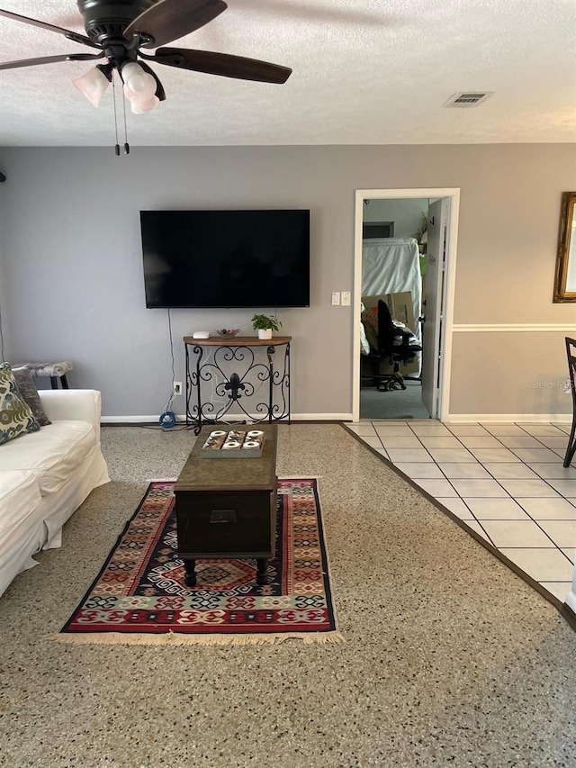 408 Blueberry Ln, Brandon, FL 33510 - living area featuring ceiling fan, speckle patterned floor, and a textured ceiling