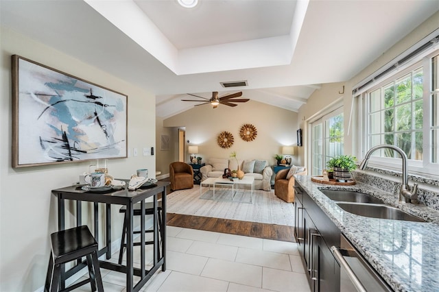 13521 Del Prado Dr S, Largo, FL 33774 - kitchen featuring light stone countertops, ceiling fan, lofted ceiling, tile patterned floors, and stainless steel dishwasher