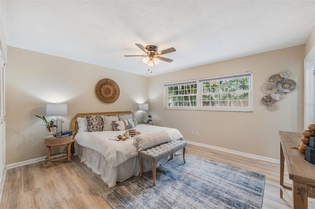 13521 Del Prado Dr S, Largo, FL 33774 - bedroom with light wood finished floors, a textured ceiling, and ceiling fan