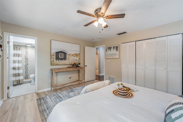 13521 Del Prado Dr S, Largo, FL 33774 - bedroom featuring wood finished floors, a closet, ensuite bath, and a ceiling fan