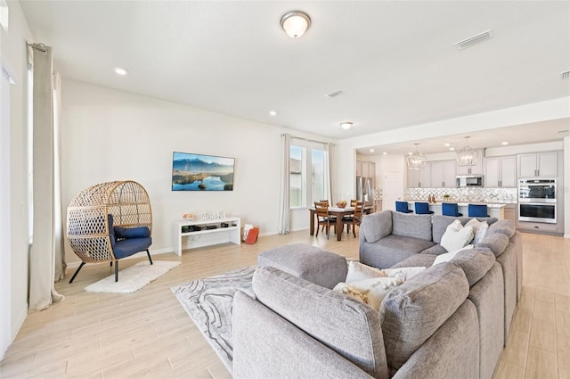11713 Tetrafin Dr, Riverview, FL 33579 - living room featuring light wood-style floors, recessed lighting, and a chandelier