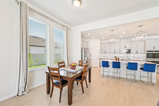 11713 Tetrafin Dr, Riverview, FL 33579 - dining space with a chandelier, light wood-style floors, plenty of natural light, and recessed lighting