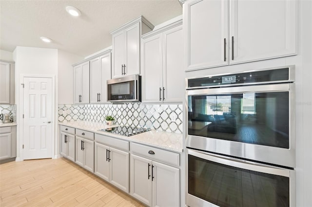 11713 Tetrafin Dr, Riverview, FL 33579 - kitchen with stainless steel appliances, backsplash, light wood-type flooring, recessed lighting, and light stone countertops