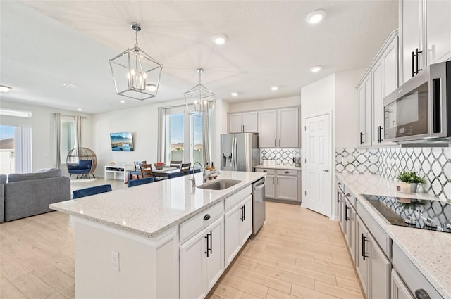 11713 Tetrafin Dr, Riverview, FL 33579 - kitchen featuring stainless steel appliances, a chandelier, open floor plan, light wood-style floors, and recessed lighting