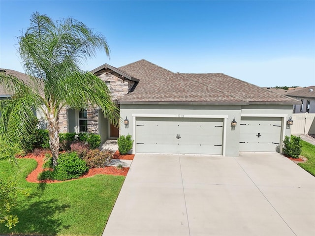 11713 Tetrafin Dr, Riverview, FL 33579 - view of front facade with stone siding, an attached garage, concrete driveway, and stucco siding