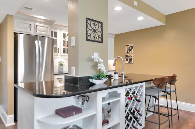 4141 Bayshore Blvd Unit 304, Tampa, FL 33611 - kitchen featuring open shelves, freestanding refrigerator, a kitchen bar, dark countertops, and white cabinets