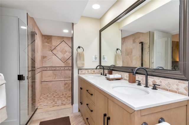 4141 Bayshore Blvd Unit 304, Tampa, FL 33611 - bathroom featuring double vanity, a shower stall, decorative backsplash, and recessed lighting