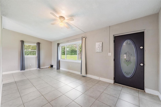 15008 Spokane Rd, Spring Hill, FL 34610 - foyer entrance featuring ceiling fan, light tile patterned floors, and a textured ceiling