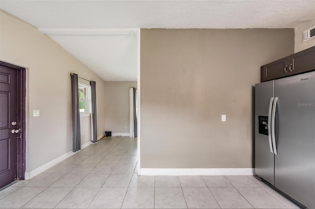 15008 Spokane Rd, Spring Hill, FL 34610 - kitchen with stainless steel refrigerator with ice dispenser and light tile patterned flooring