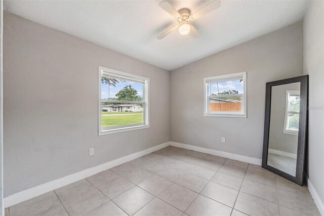 15008 Spokane Rd, Spring Hill, FL 34610 - spare room with lofted ceiling, light tile patterned floors, and ceiling fan
