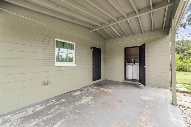 15008 Spokane Rd, Spring Hill, FL 34610 - doorway to property featuring separate washer and dryer, a patio area, and a carport