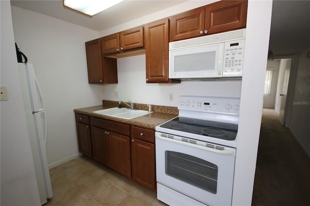 1235 S Highland Ave Unit 5-209, Clearwater, FL 33756 - kitchen featuring white appliances, dark countertops, and light tile patterned floors