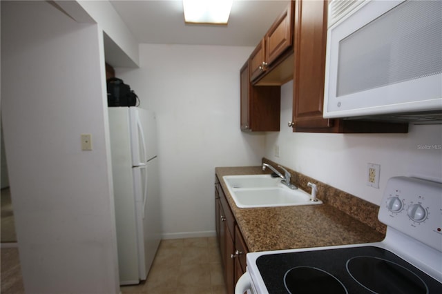 1235 S Highland Ave Unit 5-209, Clearwater, FL 33756 - kitchen featuring white appliances, dark countertops, and brown cabinetry
