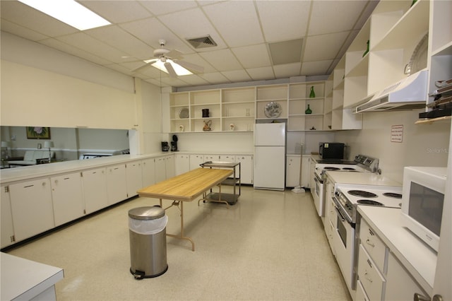 1235 S Highland Ave Unit 5-209, Clearwater, FL 33756 - kitchen with open shelves, white appliances, under cabinet range hood, a drop ceiling, and a ceiling fan
